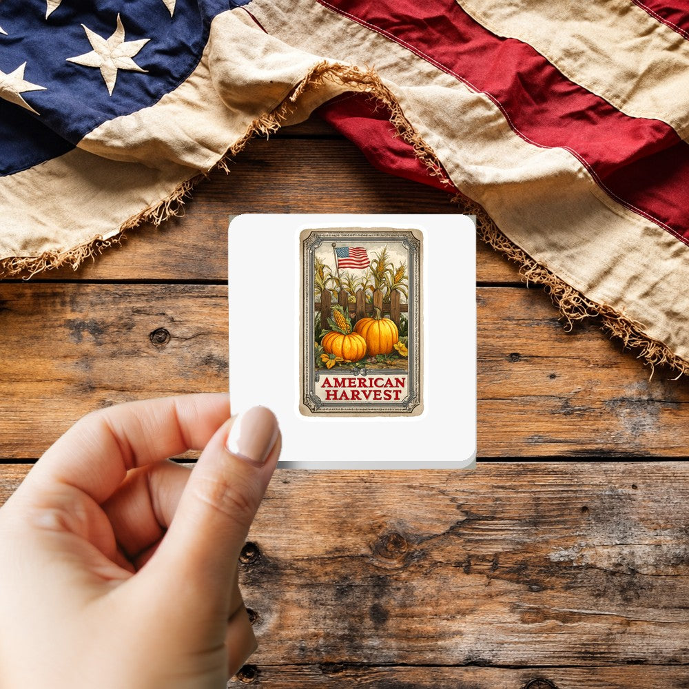 American Harvest sticker held over a vintage American flag on rustic wood, patriotic Thanksgiving gift