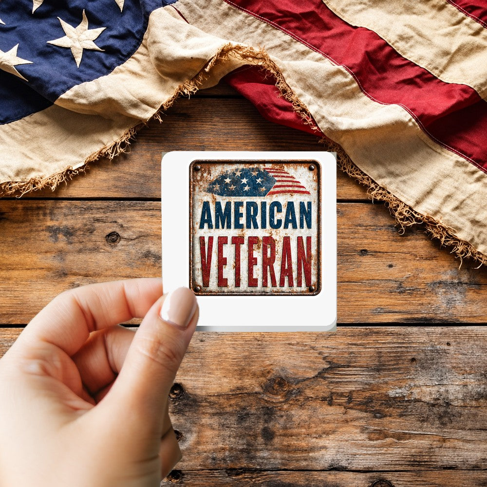 American Veteran Vintage Tin Sign sticker held over a vintage American flag on rustic wood, Veterans Day gift