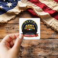 Army Veteran Cap sticker held over a vintage American flag on rustic wood, Veterans Day gift