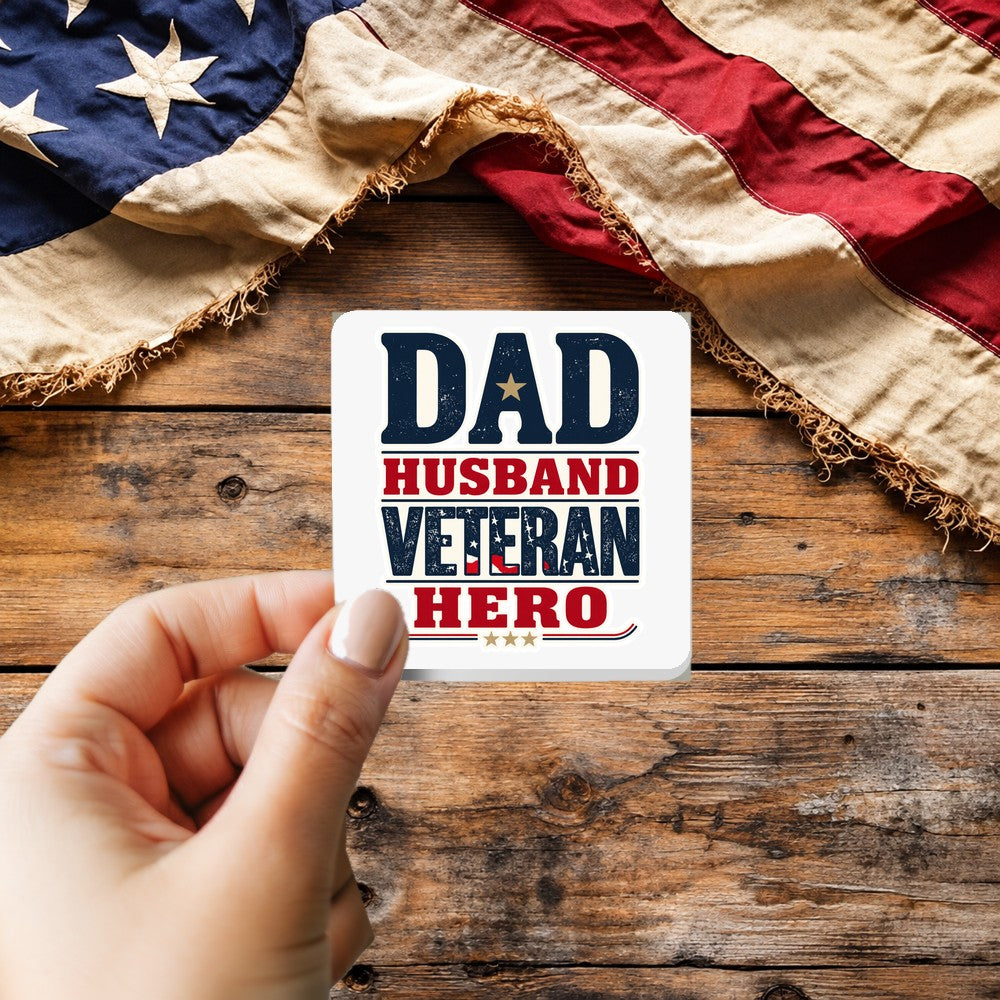 Dad Husband Veteran Hero Vintage Style sticker held over a vintage American flag on rustic wood, Veterans Day gift