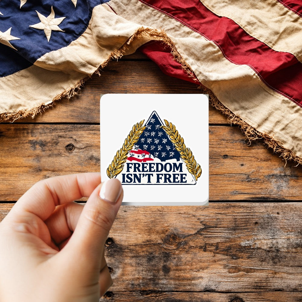 Freedom Isn't Free Patch Style sticker held over a vintage American flag on rustic wood, Veterans Day gift