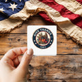 Give Thanks 1863 sticker held over a vintage American flag on rustic wood, patriotic Thanksgiving gift