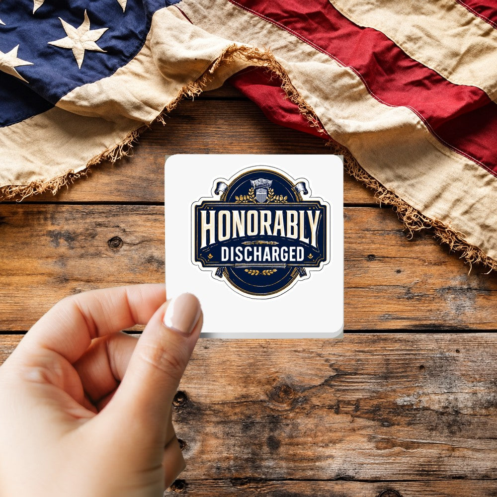 Honorably Discharged sticker held over a vintage American flag on rustic wood, Veterans Day gift