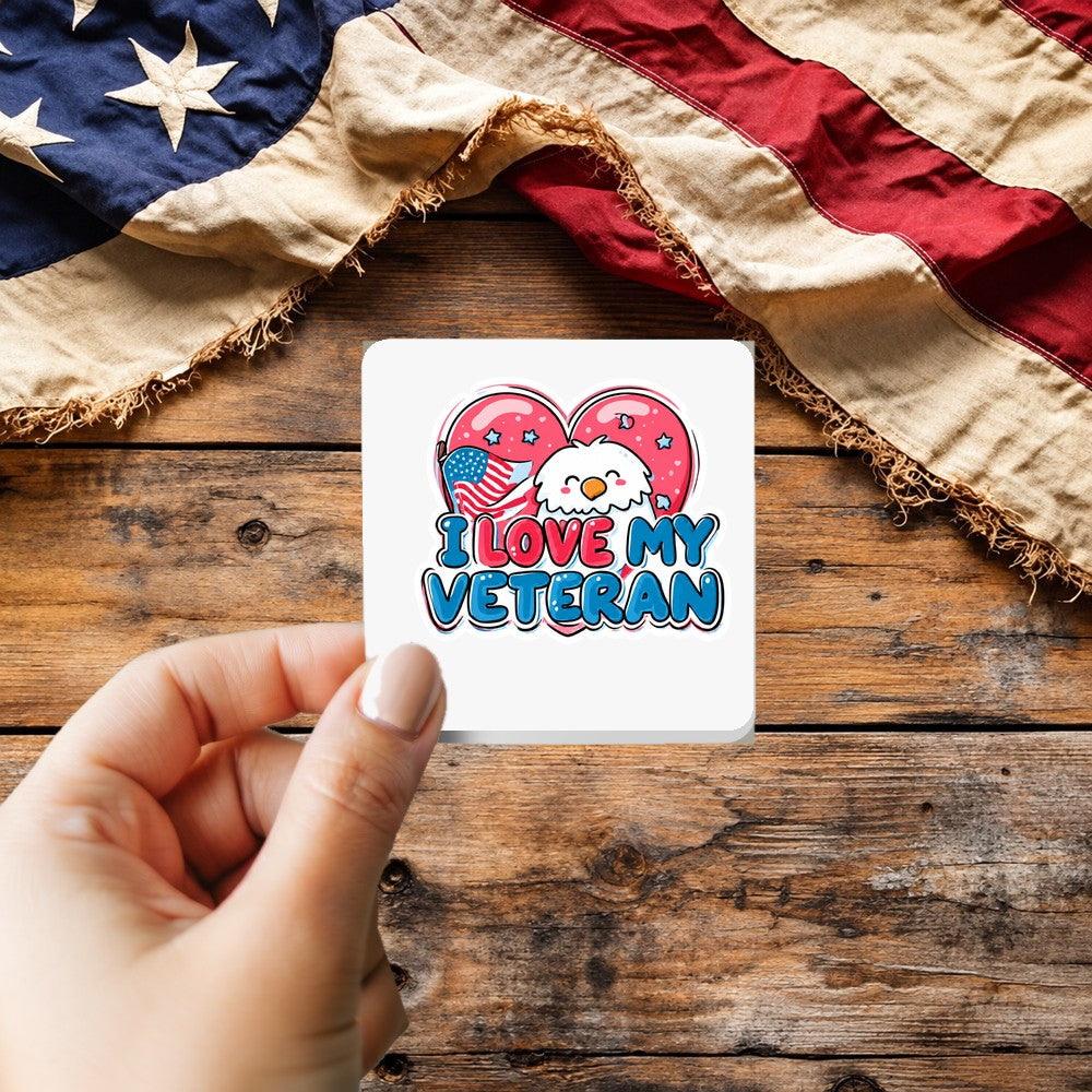 I Love My Veteran sticker held over a vintage American flag on rustic wood, Veterans Day gift