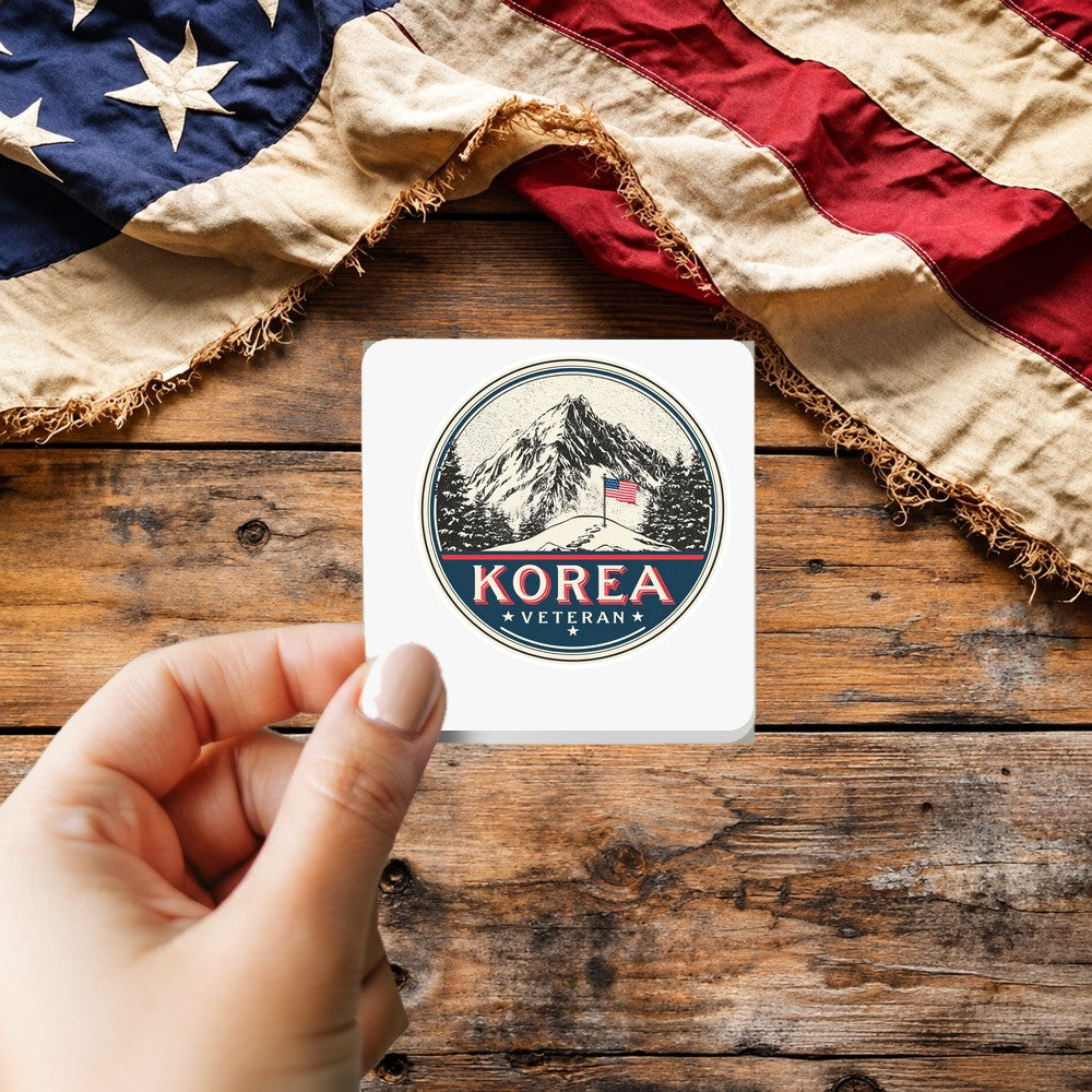 Korean War Veteran sticker held over a vintage American flag on rustic wood, Veterans Day gift