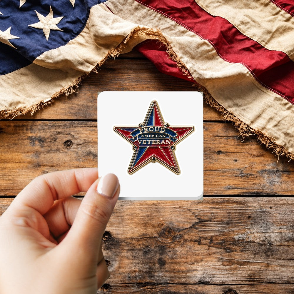 Proud American Veteran Enamel Pin Style sticker held over a vintage American flag on rustic wood, Veterans Day gift