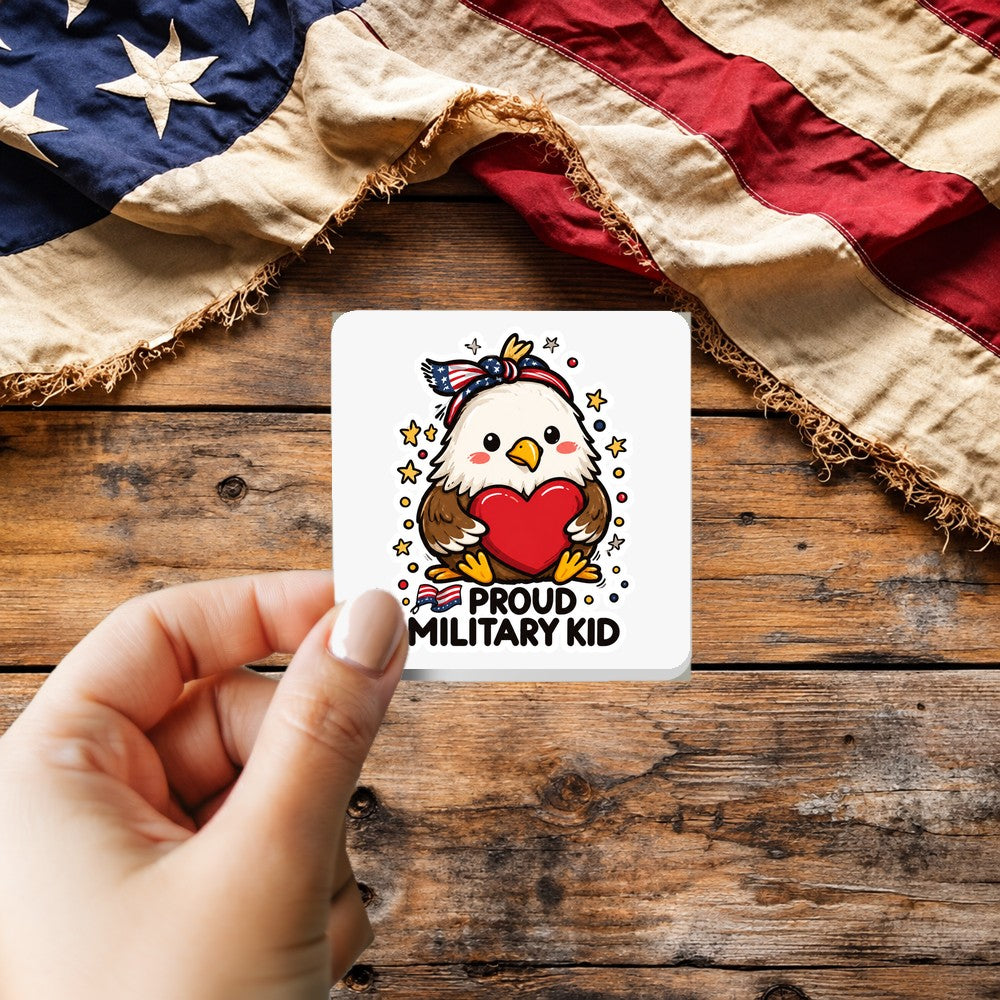 Proud Military Kid Doodle Style sticker held over a vintage American flag on rustic wood, Veterans Day gift