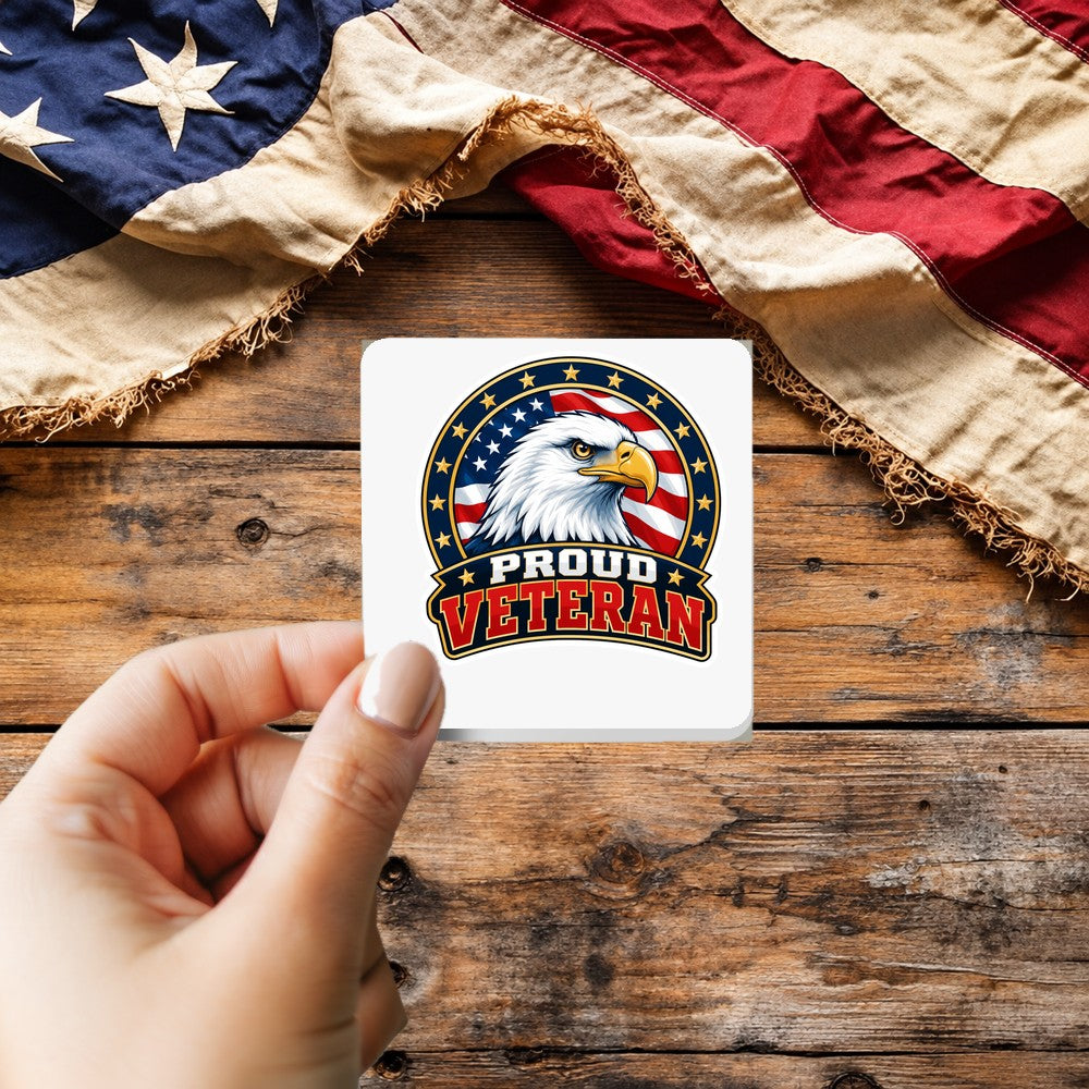 Proud Veteran Eagle sticker held over a vintage American flag on rustic wood, Veterans Day gift