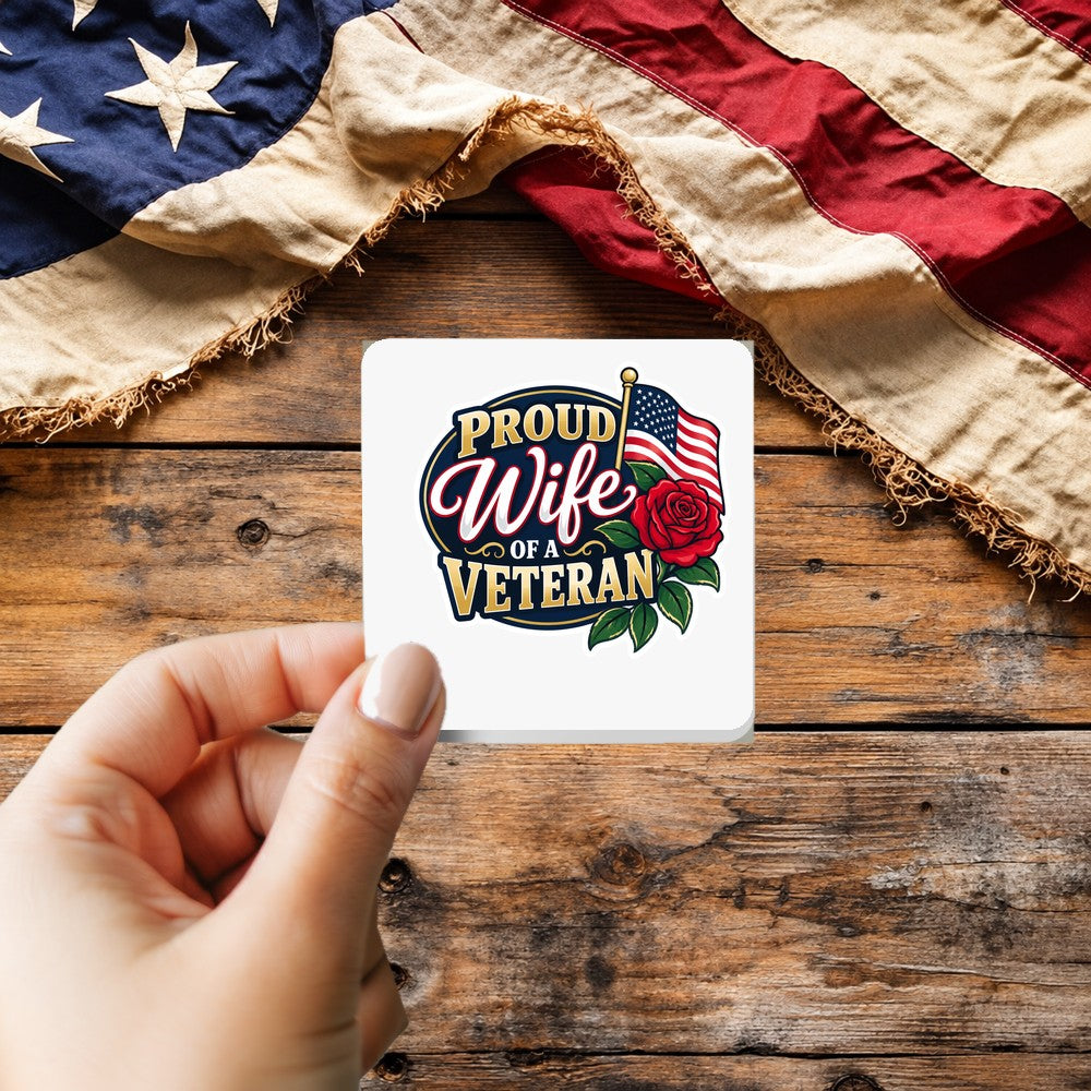 Proud Wife of a Veteran sticker held over a vintage American flag on rustic wood, Veterans Day gift