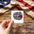 Proud Wife of a Veteran sticker held over a vintage American flag on rustic wood, Veterans Day gift