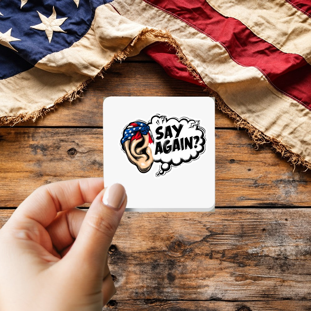 Say Again Funny Veteran sticker held over a vintage American flag on rustic wood, Veterans Day gift