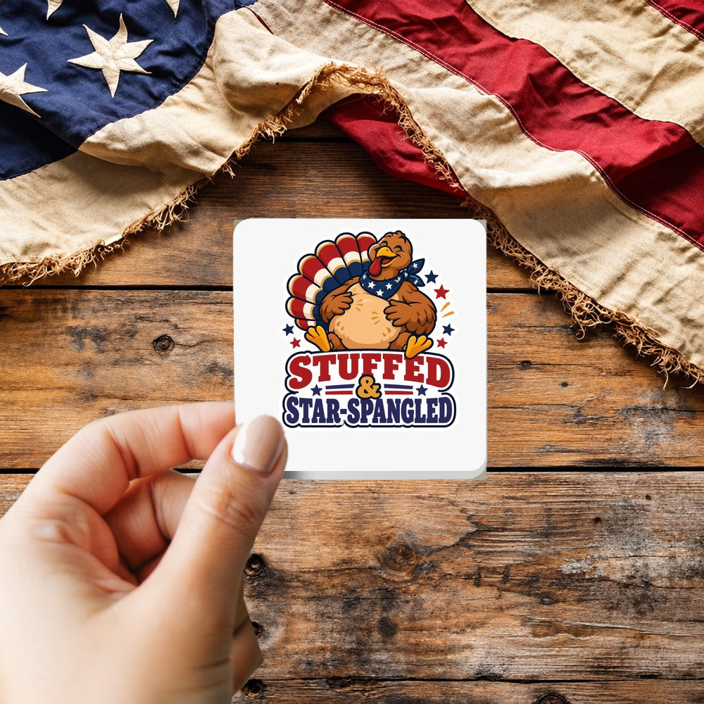 Stuffed and Star Spangled sticker held over a vintage American flag on rustic wood, patriotic Thanksgiving gift