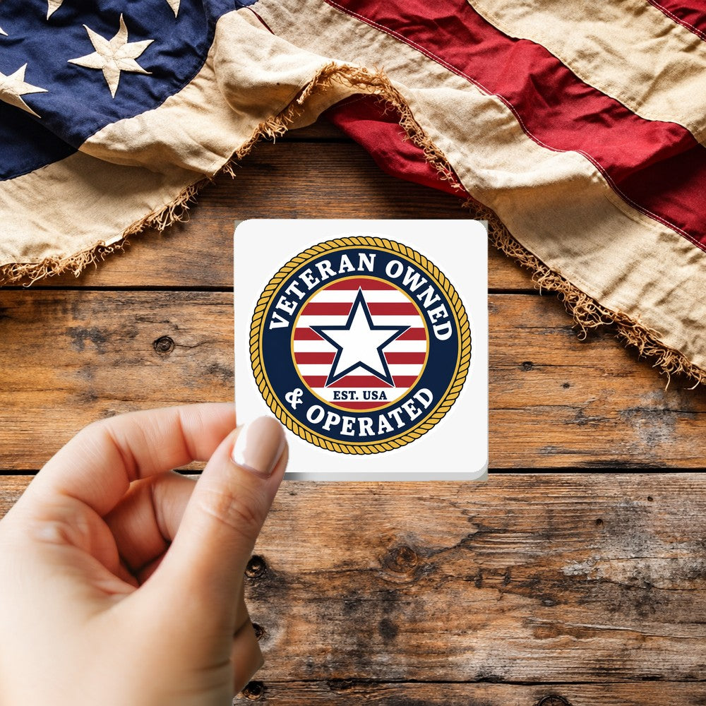 Veteran Owned and Operated sticker held over a vintage American flag on rustic wood, Veterans Day gift