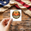 Welcome Home Vietnam Veterans sticker held over a vintage American flag on rustic wood, Veterans Day gift