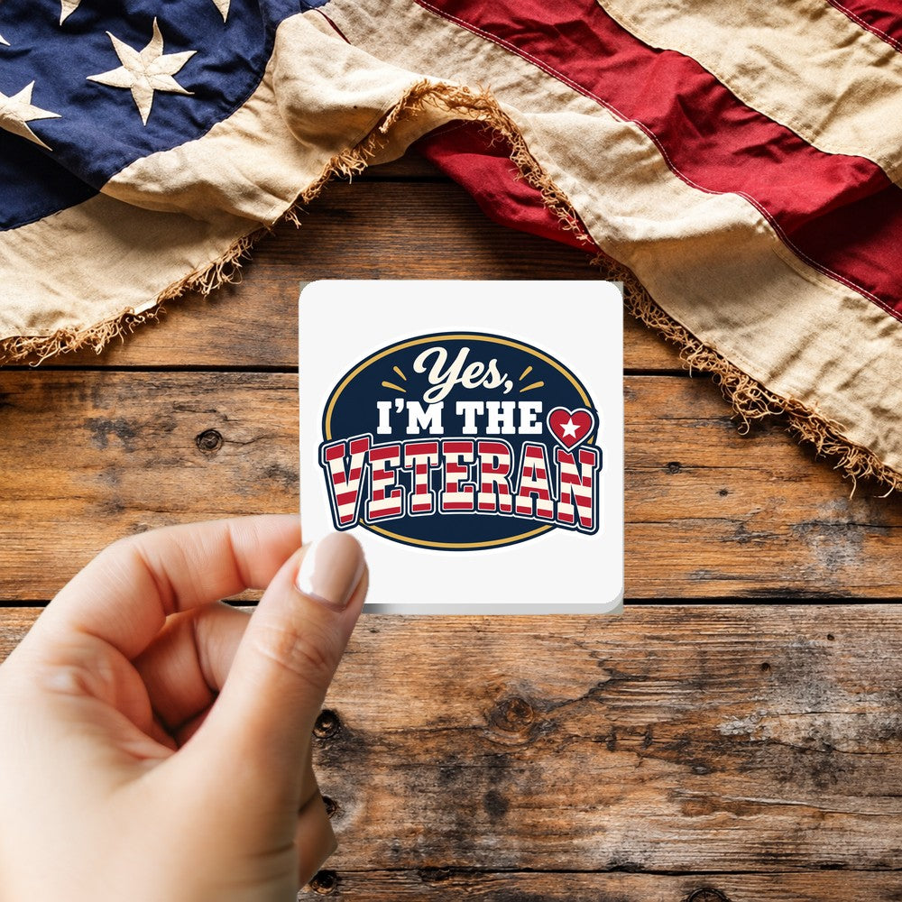 Yes I'm The Veteran sticker held over a vintage American flag on rustic wood, Veterans Day gift